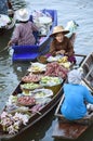 AMPHAWA Ã¢â¬â APRIL 29: Wooden boats are loaded with fruits from the orchards at Tha kha floating market Royalty Free Stock Photo